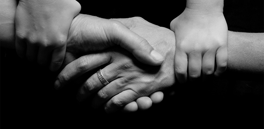 Närbild på händer som håller i varandra